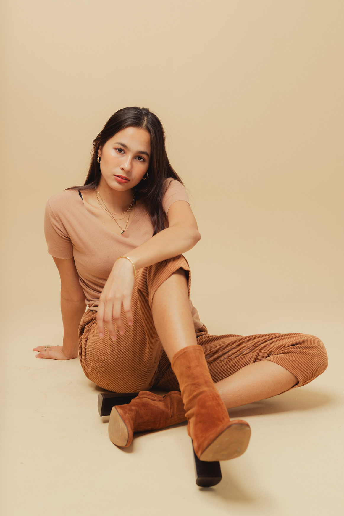 Woman in Brown Monochrome Outfit on Beige Background