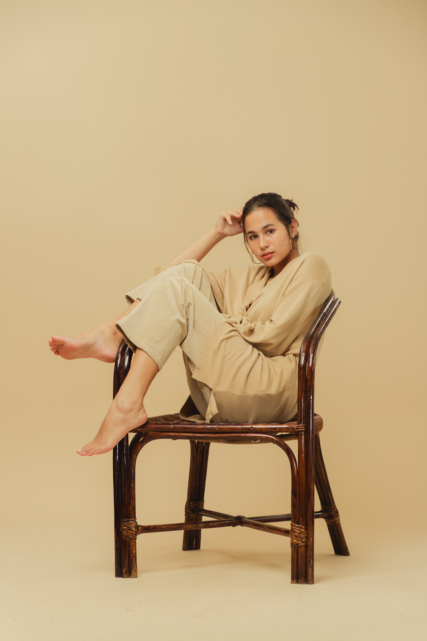 Woman in Beige Monochrome Outfit on Beige Background
